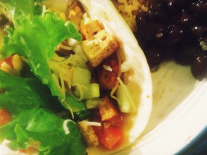 Tacos with tofu, lettuce, mango-black bean salsa, cheese and quinoa and black beans on the side. 